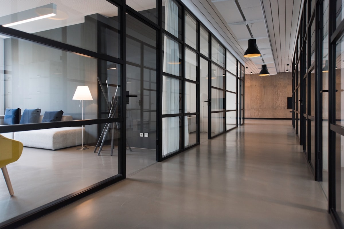 A corridor of glass-walled offices